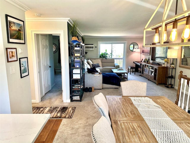 carpeted dining area featuring a baseboard heating unit, baseboards, ornamental molding, and a wall mounted air conditioner