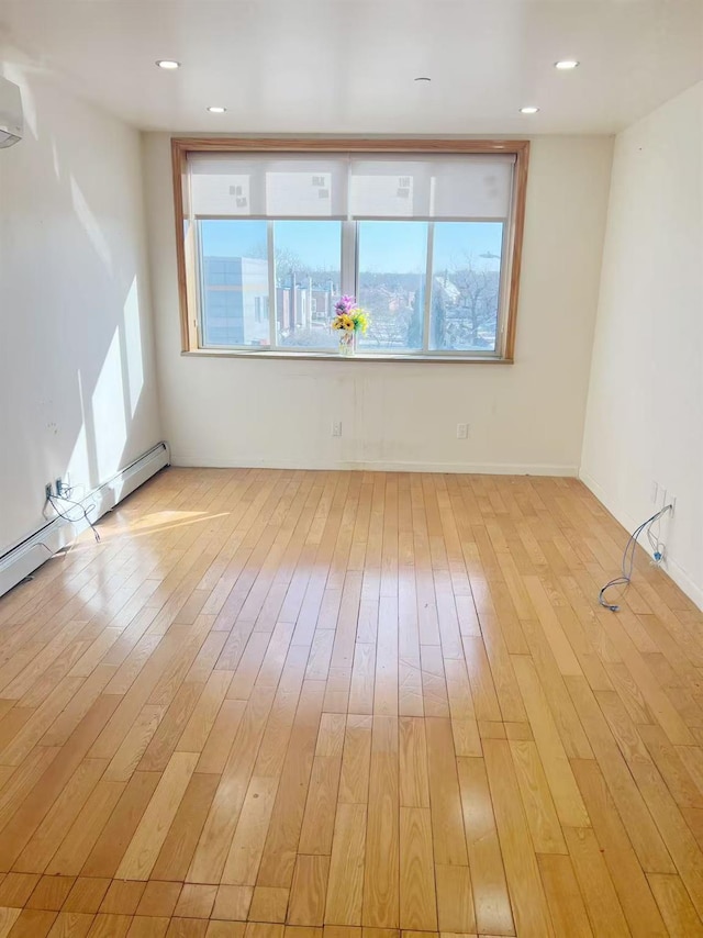 unfurnished room with plenty of natural light, light wood-style flooring, and recessed lighting