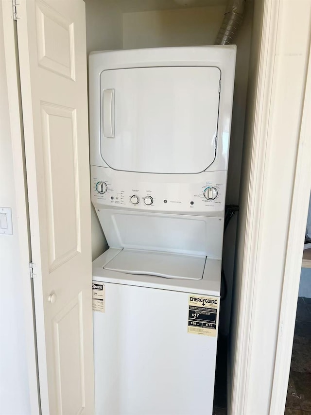 laundry room with stacked washer and dryer and laundry area