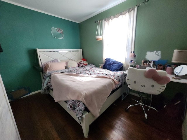 bedroom featuring ornamental molding and wood finished floors