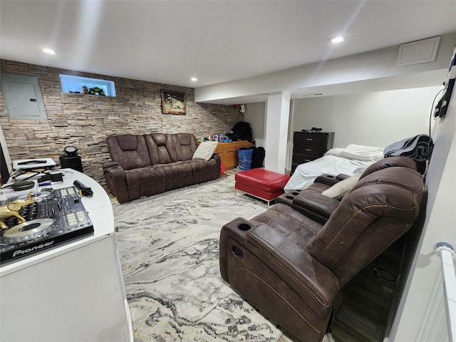 living area featuring electric panel and recessed lighting