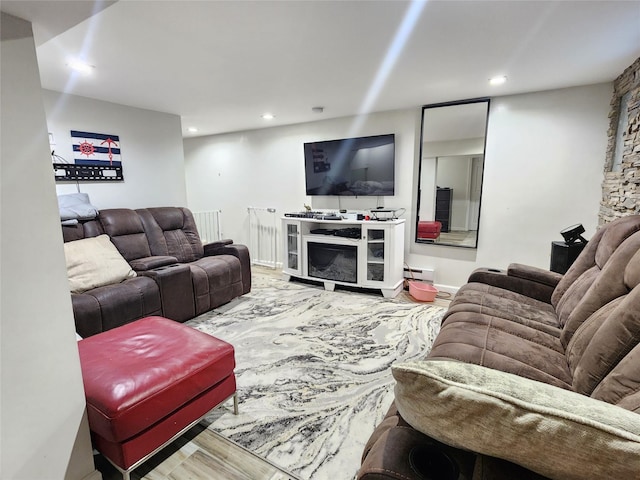 living area featuring baseboard heating, wood finished floors, and recessed lighting