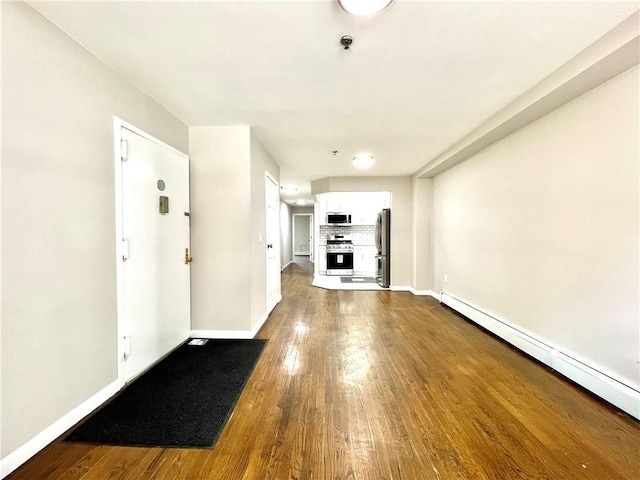 unfurnished living room featuring a baseboard radiator, a fireplace, baseboards, and dark wood-style flooring