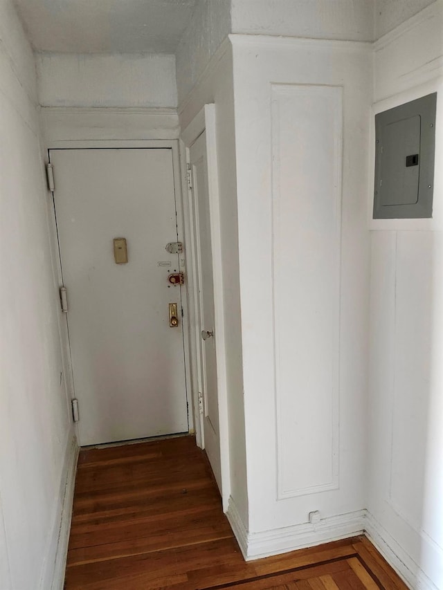 corridor featuring dark wood-type flooring and electric panel