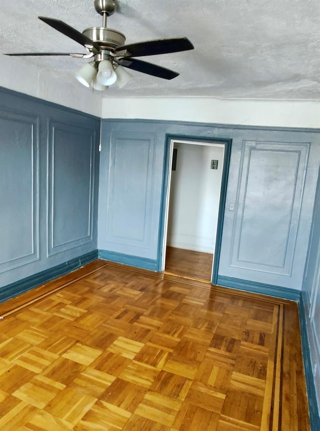 unfurnished bedroom with a textured ceiling, a closet, and a ceiling fan