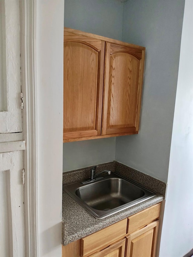 kitchen with dark countertops and a sink