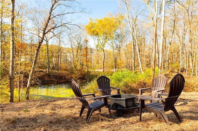 view of yard featuring a fire pit and a water view