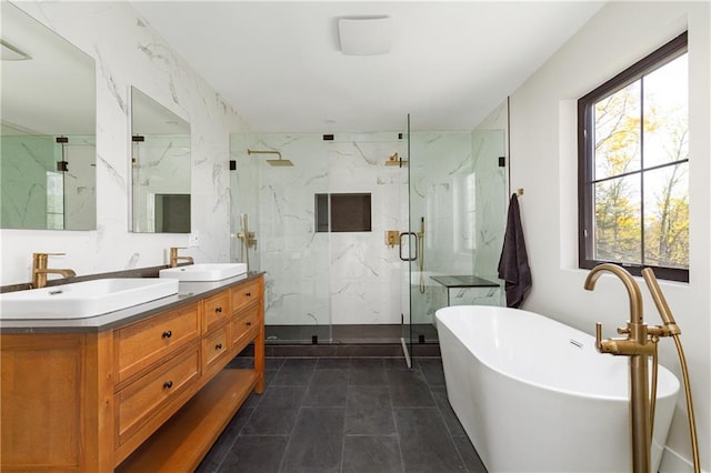 bathroom featuring double vanity, a freestanding tub, a marble finish shower, and a sink