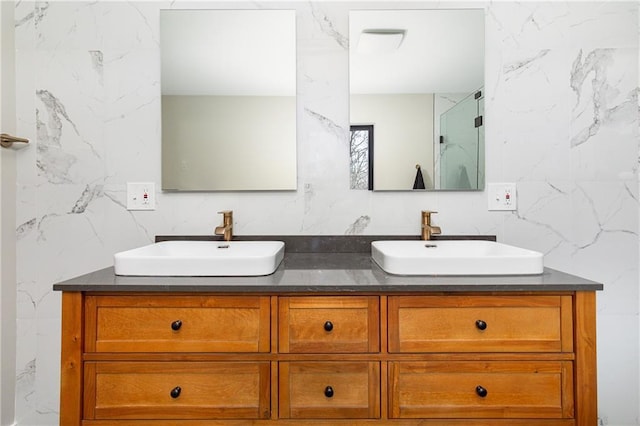 bathroom with a sink and double vanity