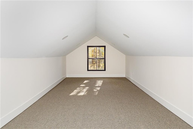 additional living space featuring lofted ceiling, carpet, and baseboards