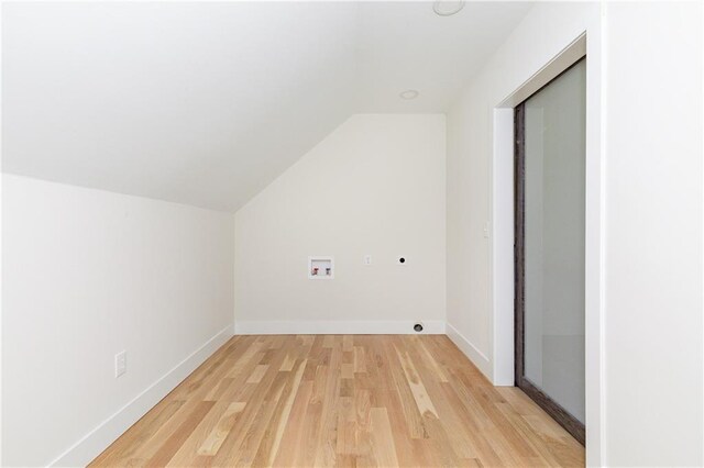 bonus room with lofted ceiling, light wood finished floors, and baseboards