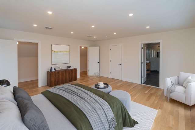 bedroom with light wood finished floors, visible vents, and recessed lighting