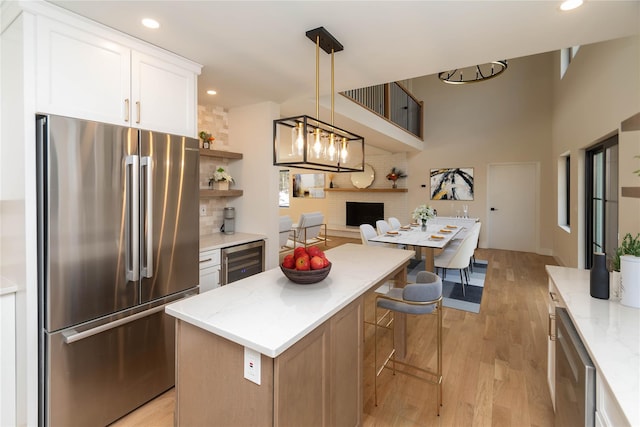 16 Shunpike, Clinton Corners, NY 12514 - kitchen featuring stainless steel fridge, wine cooler, light wood-style floors, tasteful backsplash, and white cabinets