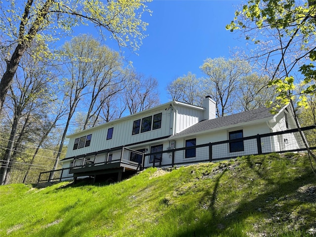 16 Shunpike, Clinton Corners, NY 12514 - back of property featuring a chimney, a deck, board and batten siding, and a lawn
