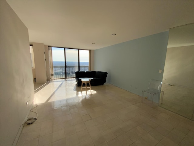 unfurnished living room with a water view and expansive windows