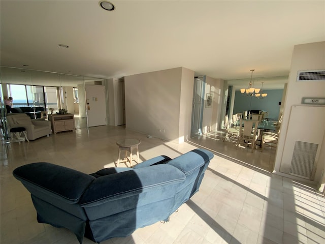 living area featuring visible vents and a chandelier