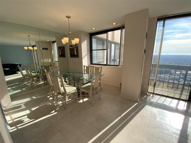 dining space featuring a chandelier and floor to ceiling windows