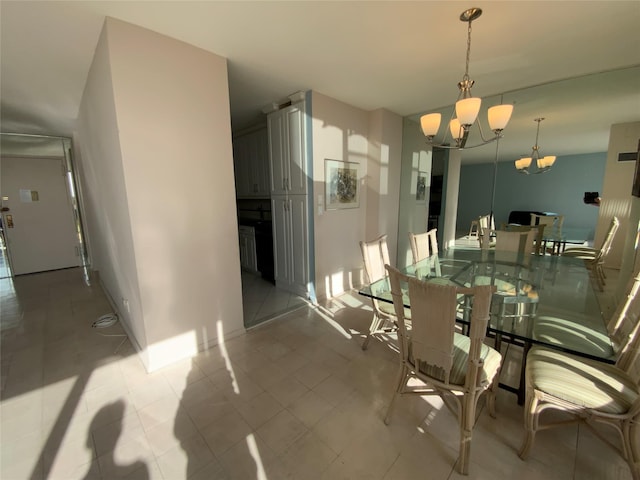 dining room featuring baseboards, light tile patterned floors, and a notable chandelier