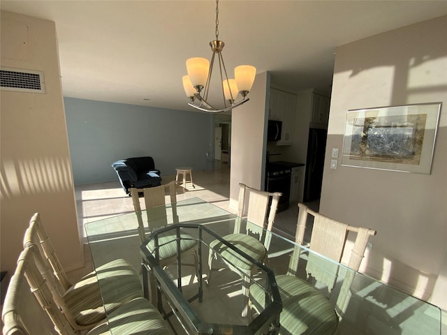 dining space featuring visible vents and an inviting chandelier