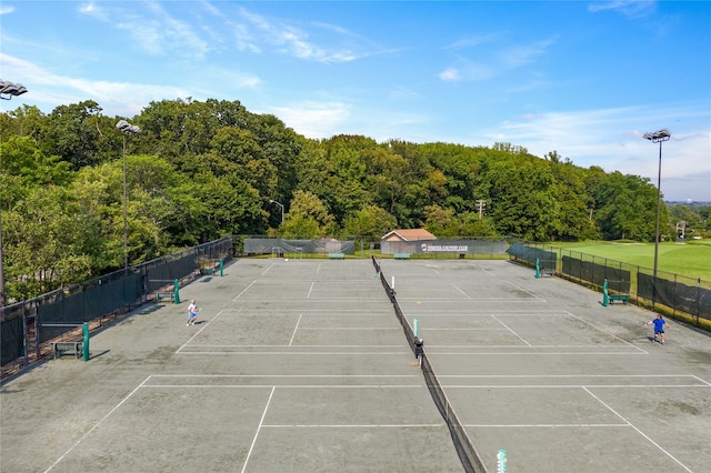 view of sport court featuring fence