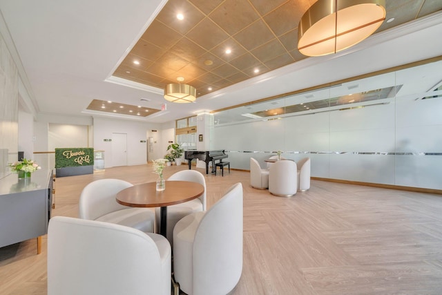 dining room featuring baseboards, a raised ceiling, crown molding, and recessed lighting