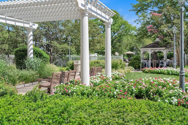 view of yard featuring a gazebo, fence, and a pergola