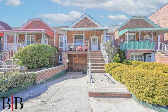 view of front of property with driveway, an attached garage, stairway, and a porch