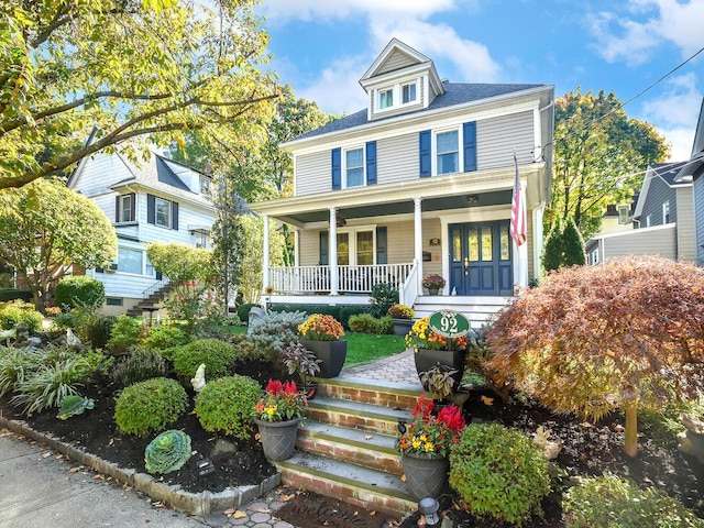 american foursquare style home with a porch