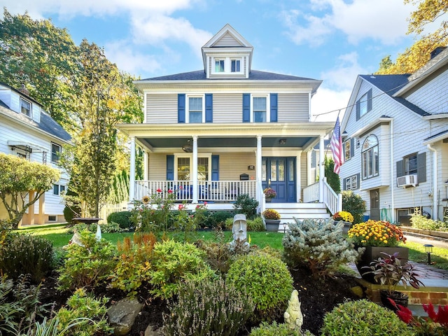 american foursquare style home with covered porch and cooling unit