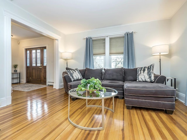 living room with hardwood / wood-style flooring, baseboards, and a baseboard heating unit