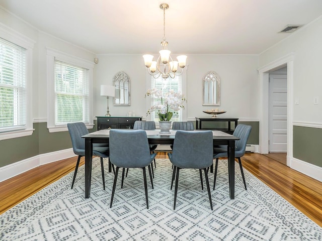 dining area with a healthy amount of sunlight, light wood-style flooring, and visible vents