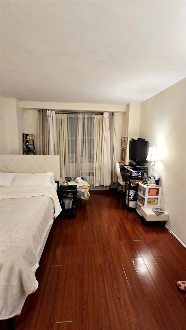 bedroom featuring dark wood finished floors