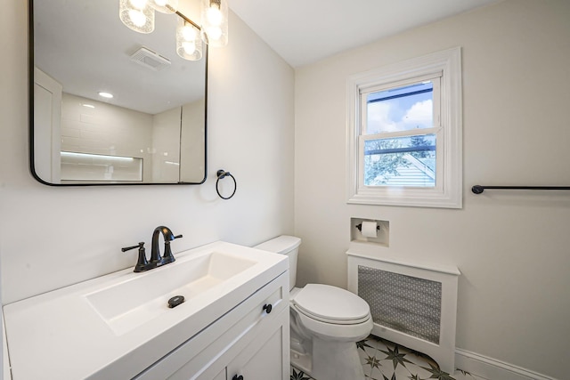 bathroom with toilet, visible vents, vanity, radiator heating unit, and walk in shower