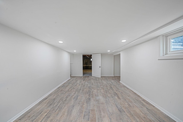 below grade area featuring recessed lighting, light wood-style flooring, and baseboards