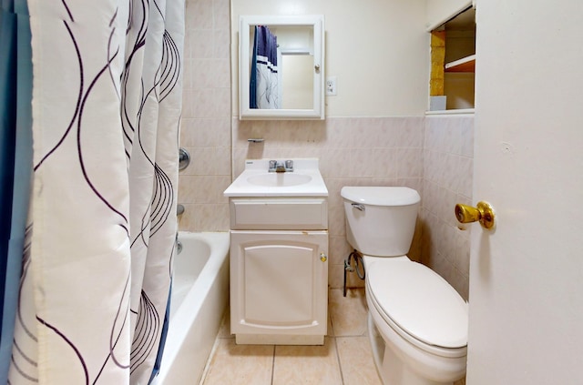 bathroom featuring toilet, shower / tub combo, vanity, tile walls, and tile patterned floors