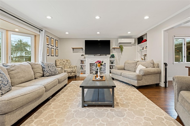 living area with a wall mounted air conditioner, dark wood-type flooring, recessed lighting, and crown molding