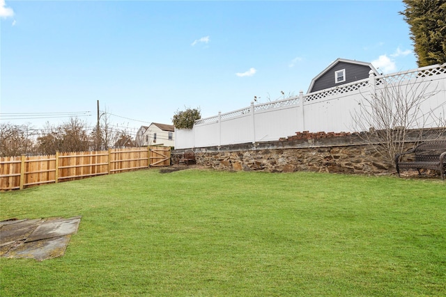 view of yard with a fenced backyard