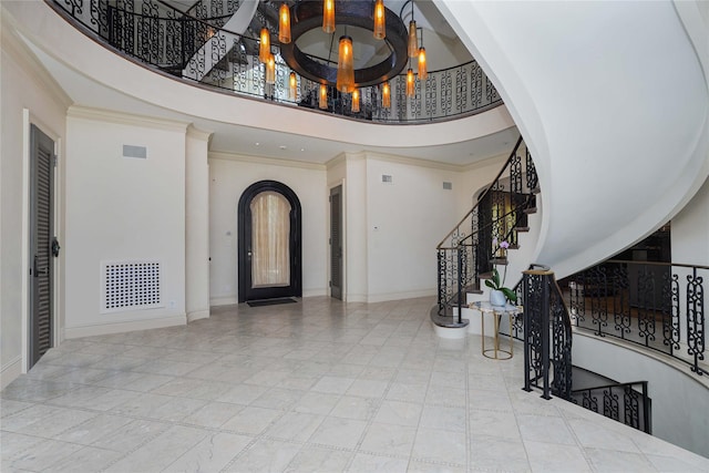 86 Gaylord Dr S, Brooklyn, NY 11234 - foyer with baseboards, visible vents, arched walkways, stairway, and ornamental molding