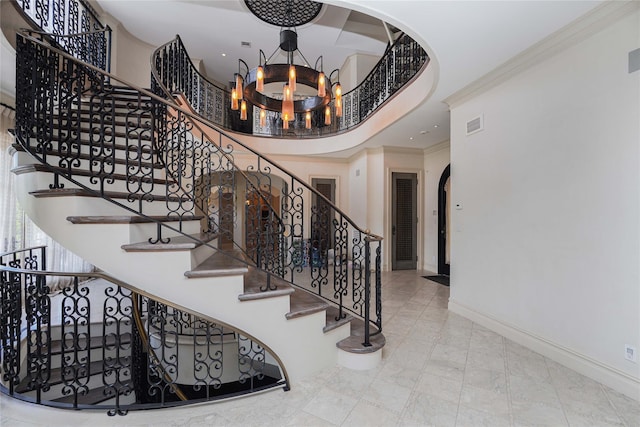 86 Gaylord Dr S, Brooklyn, NY 11234 - stairway featuring baseboards, visible vents, arched walkways, ornamental molding, and a chandelier