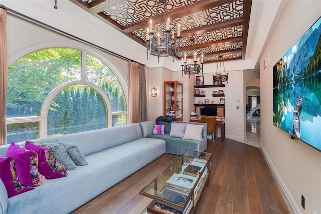86 Gaylord Dr S, Brooklyn, NY 11234 - living room featuring arched walkways, dark wood-style flooring, a notable chandelier, and baseboards