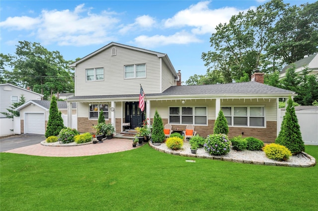 traditional home with covered porch, driveway, and a front lawn