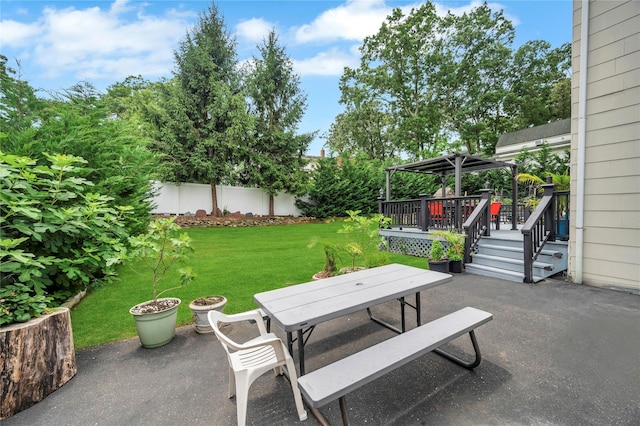 view of patio / terrace featuring a deck, a gazebo, outdoor dining area, and fence