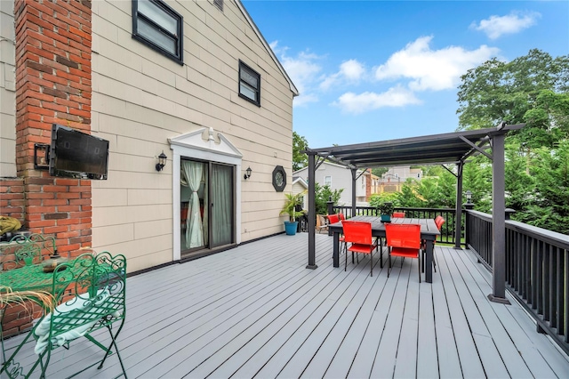 wooden deck with outdoor dining area and a pergola