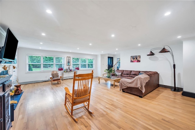 living room with recessed lighting, light wood-style flooring, and a healthy amount of sunlight