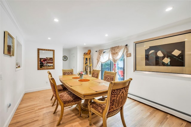 dining area with a baseboard heating unit, ornamental molding, light wood-style flooring, and recessed lighting