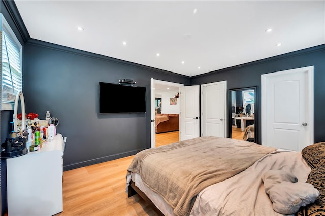 bedroom featuring ornamental molding, light wood-type flooring, baseboards, and recessed lighting