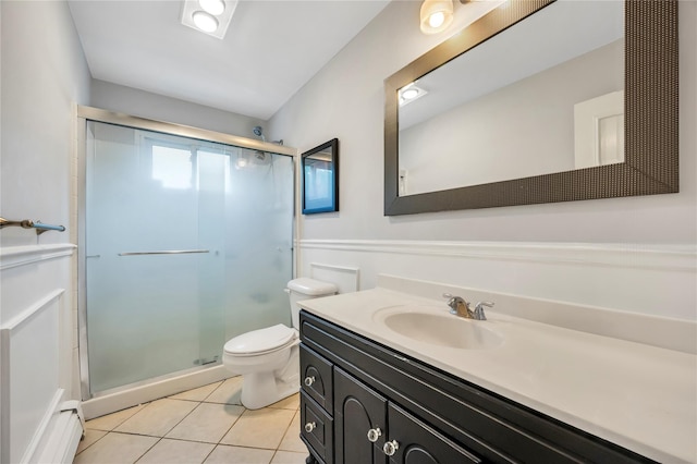 full bathroom featuring a stall shower, tile patterned flooring, vanity, and toilet