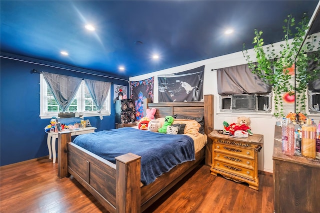 bedroom featuring cooling unit, dark wood finished floors, and recessed lighting