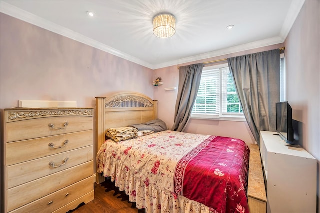 bedroom featuring dark wood finished floors and crown molding