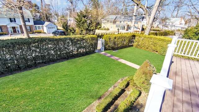 view of yard featuring a residential view and fence